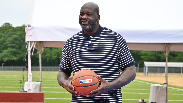 Shaquille O'Neal holds a basketball