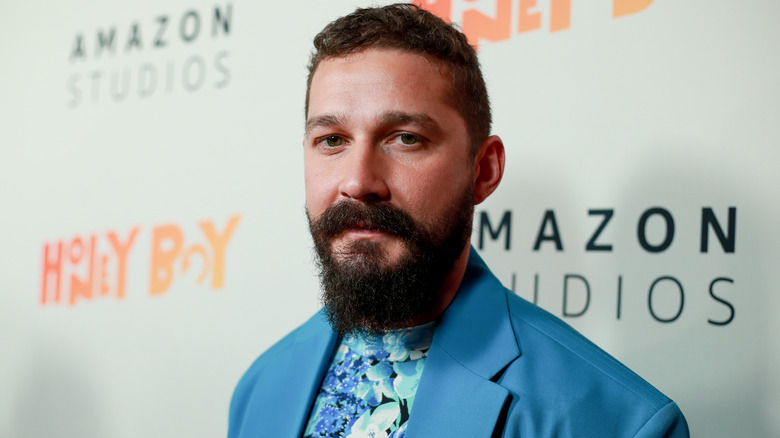 Shia LaBeouf posing in blue outfit