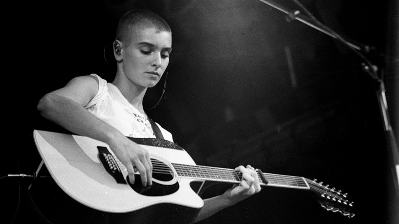 Sinéad O'Connor playing guitar