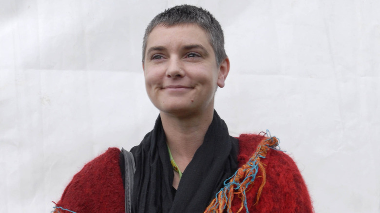 Sinéad O'Connor wearing a multi-colored coat