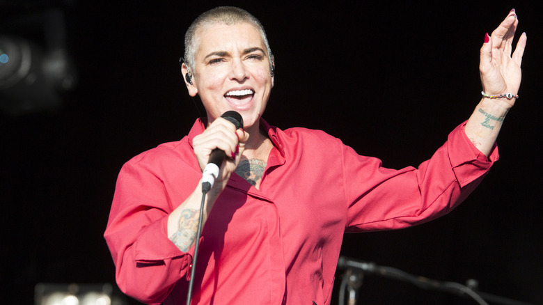 Sinéad O'Connor performing in a red shirt