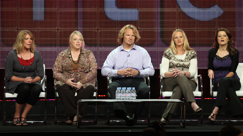 Koby Brown and wives sitting on stage