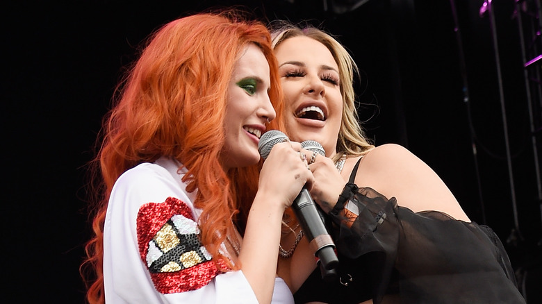 Tana Mongeau and Bella Thorne performing on stage