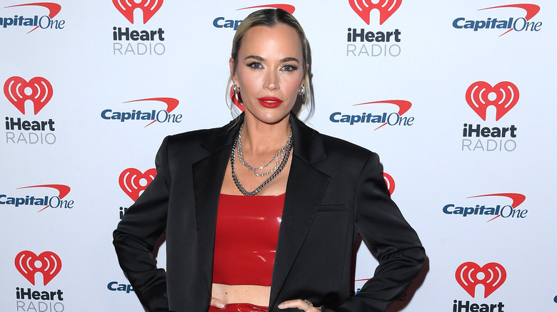 Teddi Mellencamp wearing red lipstick, a red crop top, and a black blazer