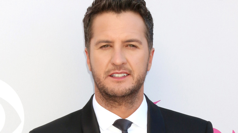 Luke Bryan posing in suit