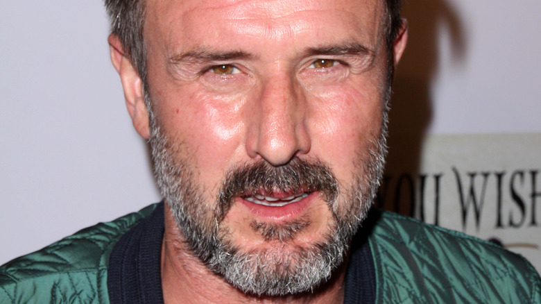 David Arquette squinting with grey beard