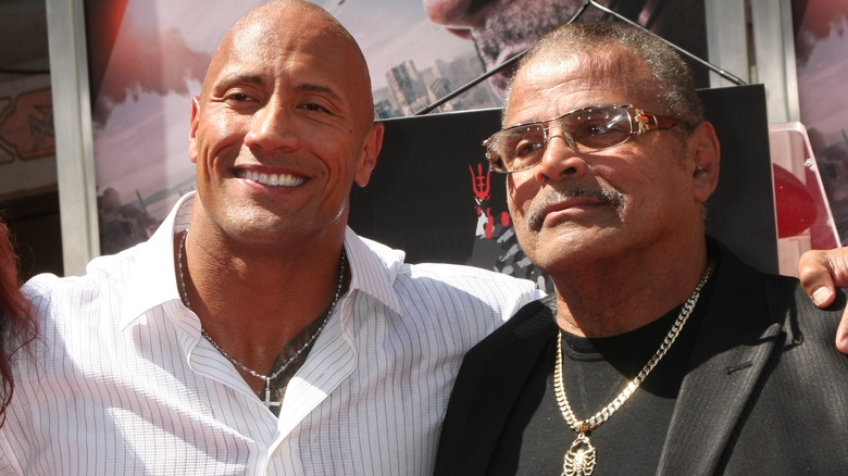 Dwayne and Rocky Johnson posing 