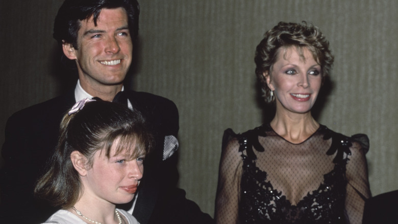 Pierce Brosnan, Cassandra Harris, and Charlotte Brosnan smiling