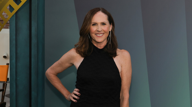 Molly Shannon smiling and posing in a black gown