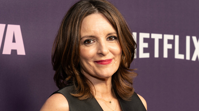 Tina Fey smiling for photographers at an event