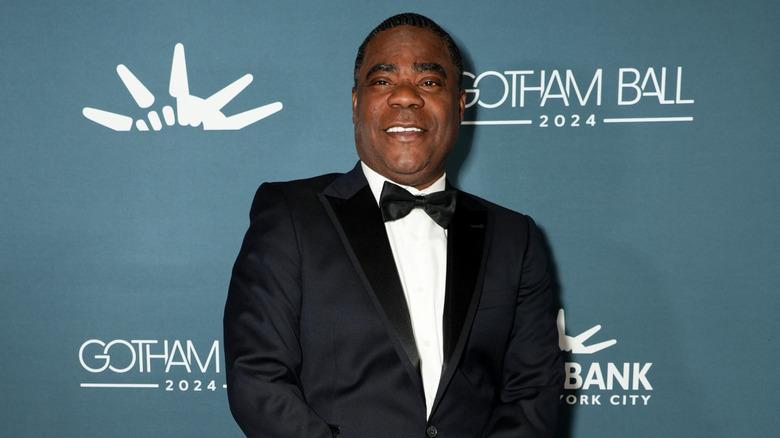 Tracy Morgan smiling in a tuxedo while posing for photographers