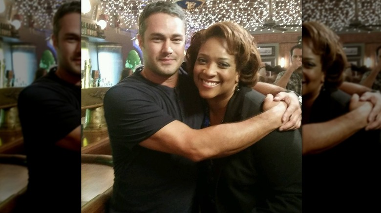 Taylor Kinney hugging DuShon Monique Brown