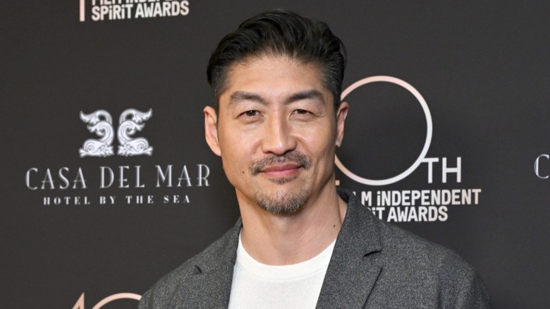 Brian Tee smiling for photographs