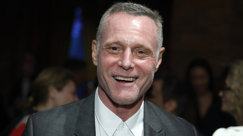 Jason Beghe smiling widely at event