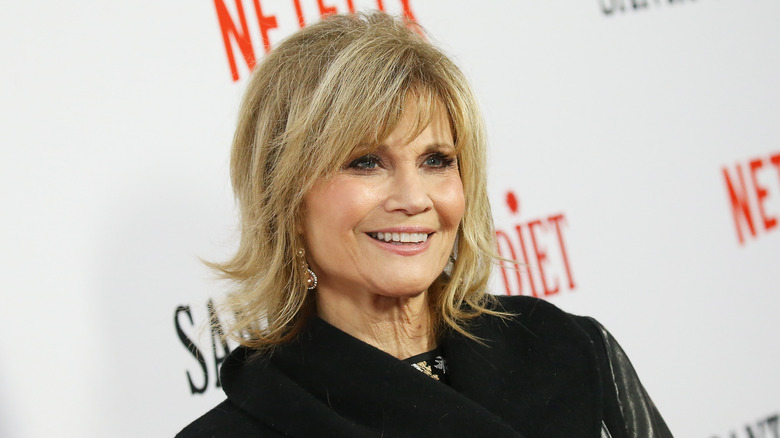 Markie post smiling on red carpet