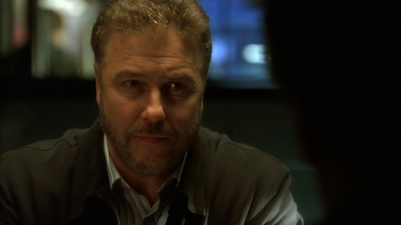 William Petersen as Gil Grissom, seated