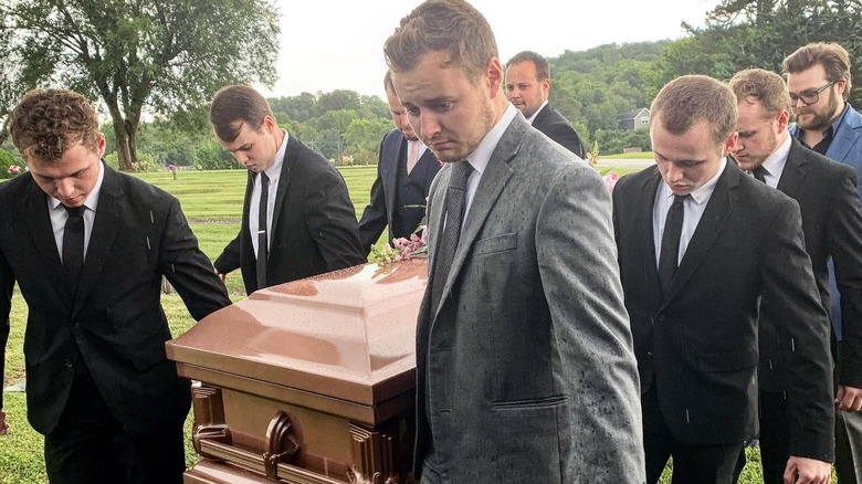 Duggar men carrying casket