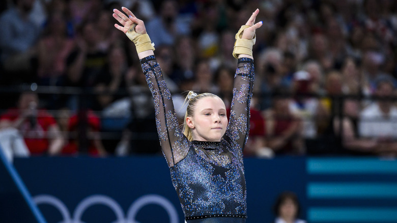 Jade Carey wearing wrist braces and a sparkling star-bedazzled leotard