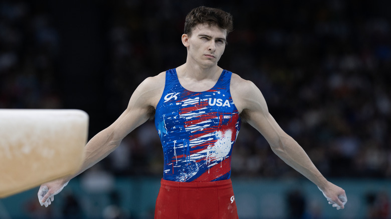 Stephen Nedoroscik squinting while wearing a red, white and blue tank top and pants