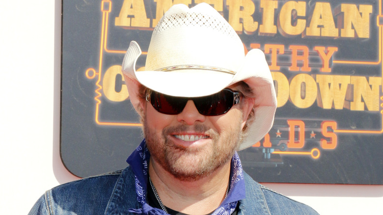 Toby Keith in black sunglasses and cowboy hat