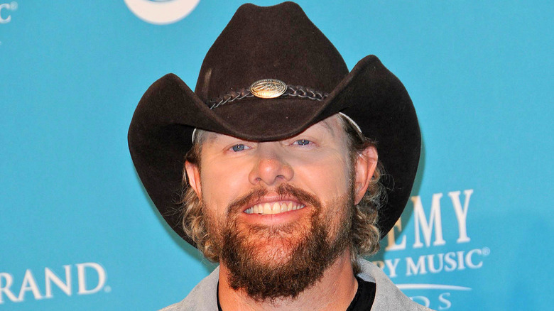 Toby Keith smiling in black cowboy hat 