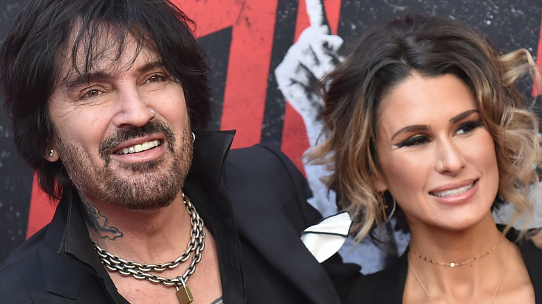 Tommy Lee and Brittany Furlan smiling on red carpet