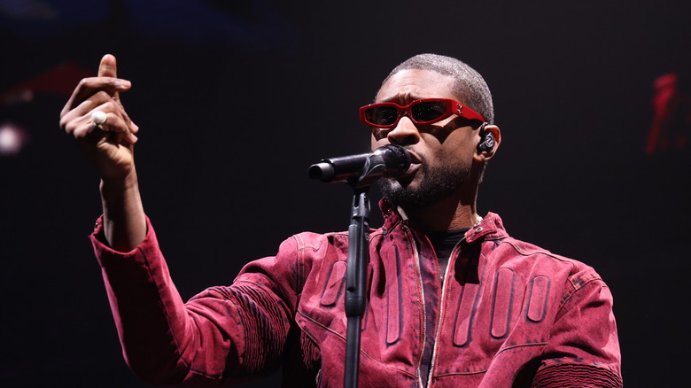 Usher performing in red outfit