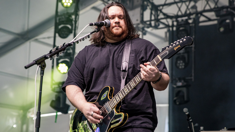 Wolfgang Van Halen strumming guitar