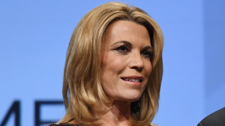 Vanna White in front of a blue background