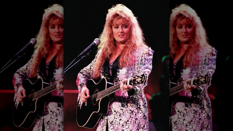 Wynonna Judd with bangs playing guitar