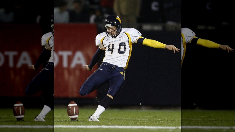 Pat McAfee kicking a football during a West Virginia University Mountaineers game