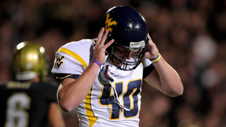 Pat McAfee removing his helmet during WVU game