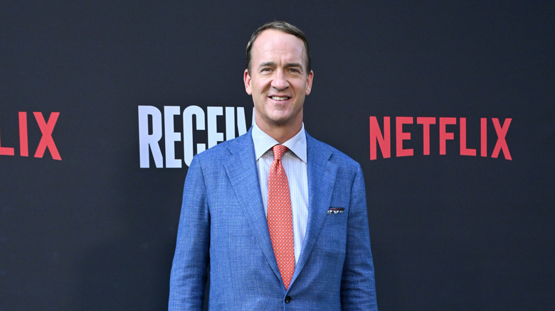 Peyton Manning poses on a red carpet