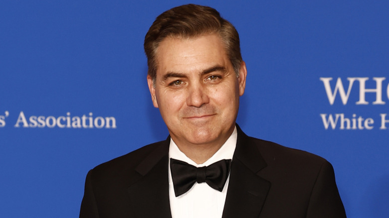 Jim Acosta posing on the red carpet.