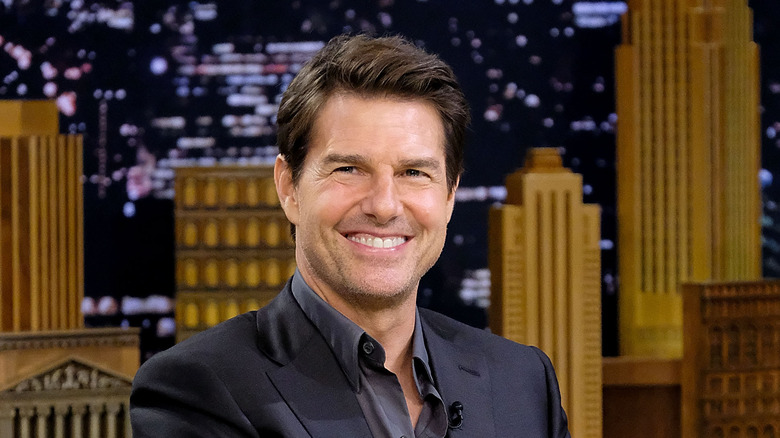 Tom Cruise smiling in a talk show guest chair