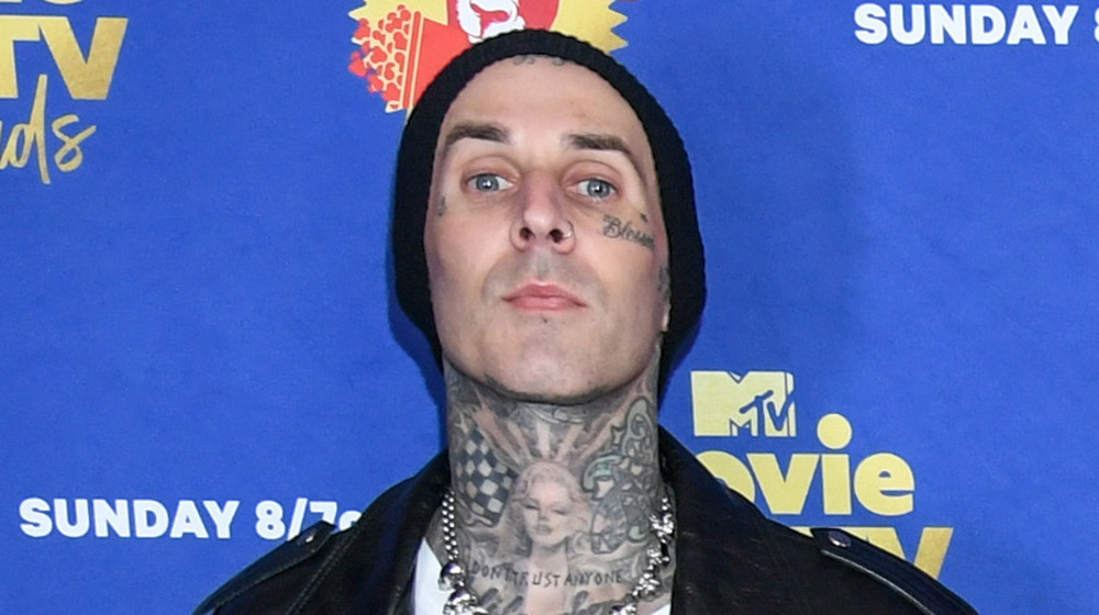 Travis Barker wears a leather jacket on the red carpet