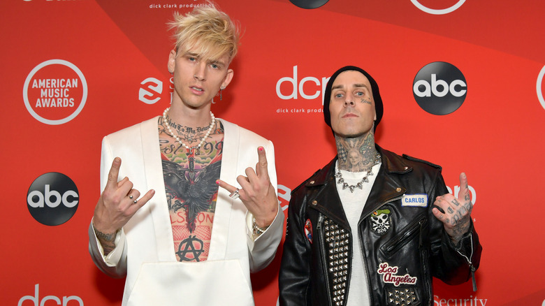 Machine Gun Kelly, Travis Barker making hand gestures