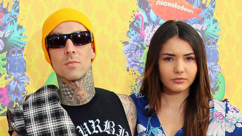 Travis Barker posing next to Atiana De La Hoya 