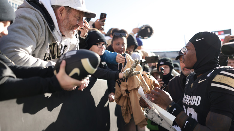 Travis Hunter signing autographs for fans