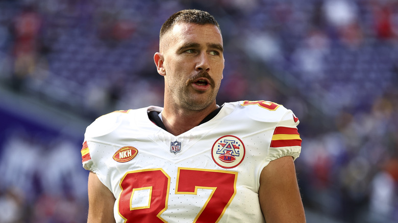 Travis Kelce playing football in white jersey