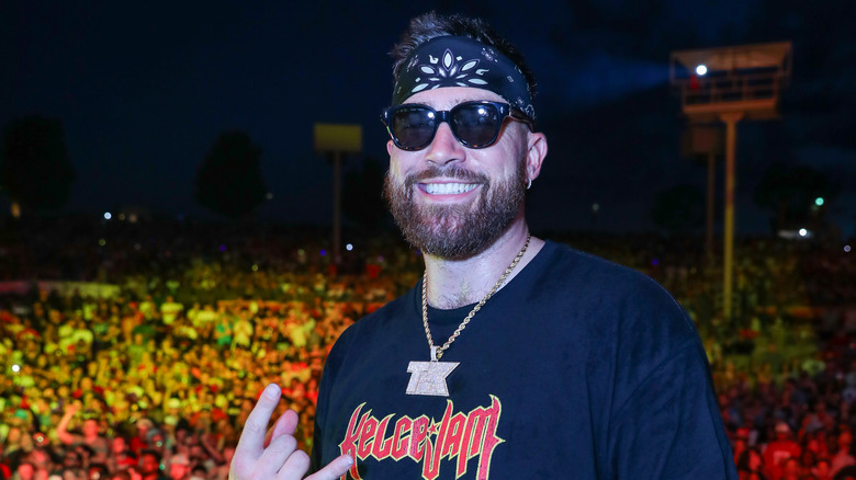 Travis Kelce wearing bandana, sunglasses