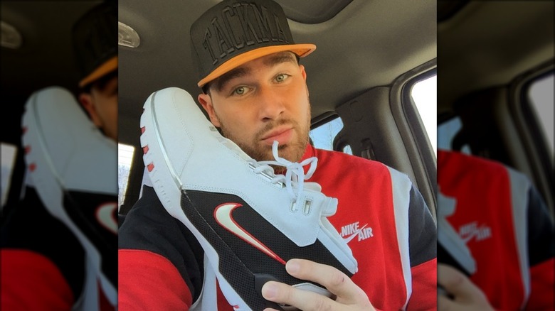 Travis Kelce holding Nike shoe