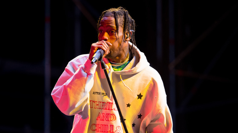 Travis Scott performs in sweatshirt