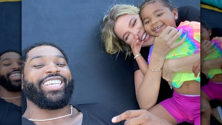 Tristan Thompson smiling with True and Khloe