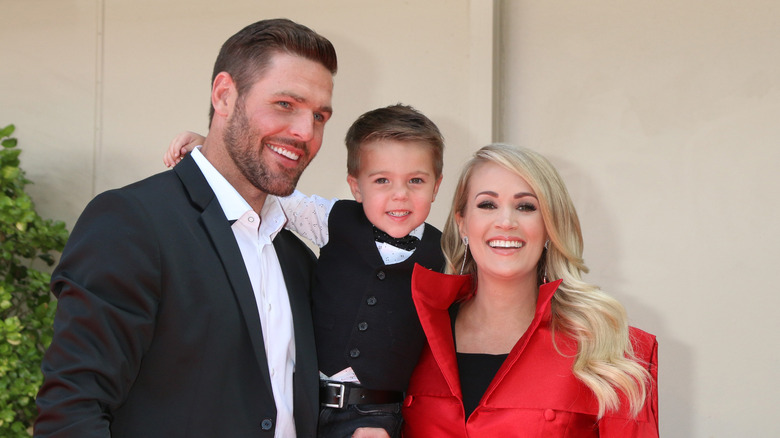 Mike Fisher and Carrie Underwood with their son