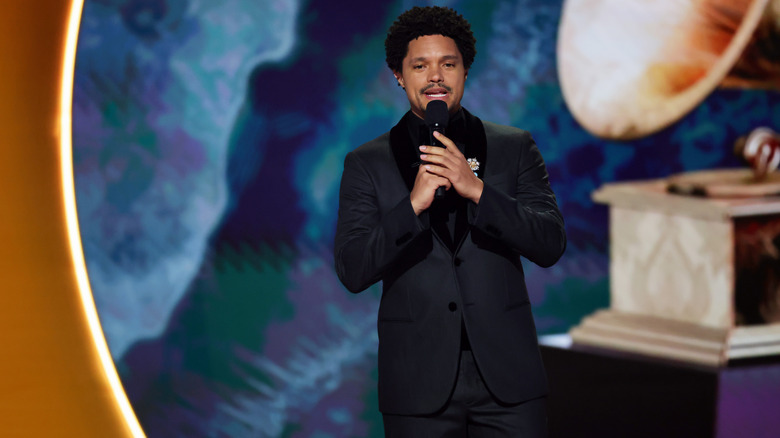 Trevor Noah speaking on stage at the 2025 Grammys