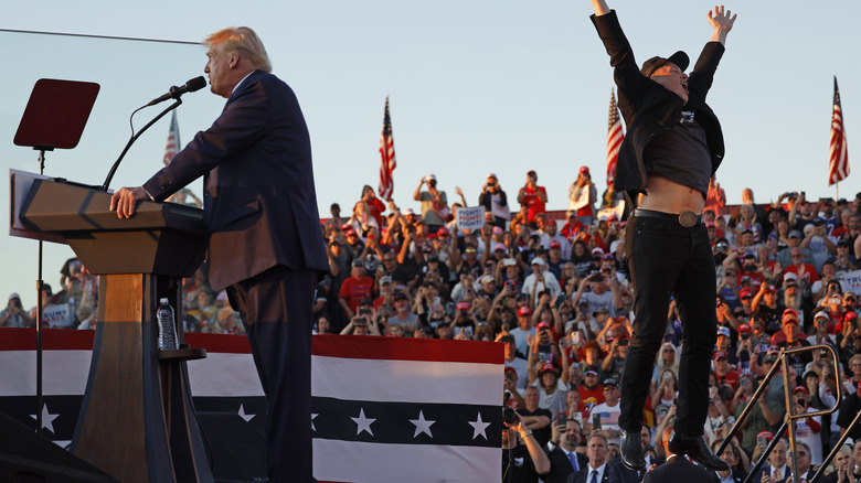 Donald Trump speaking as Elon Musk leaps