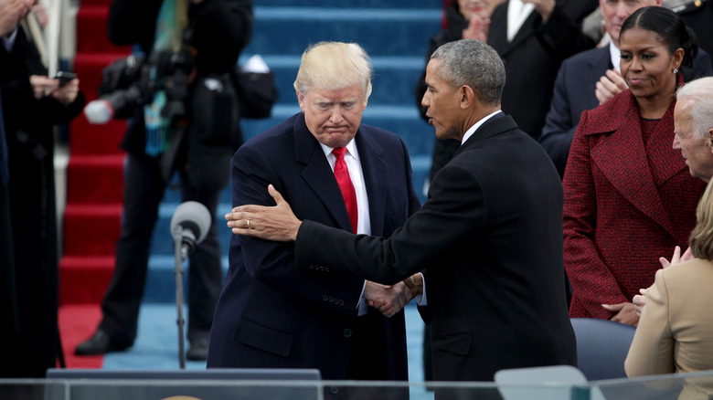 Barack Obama putting hand on Donald Trump's arm