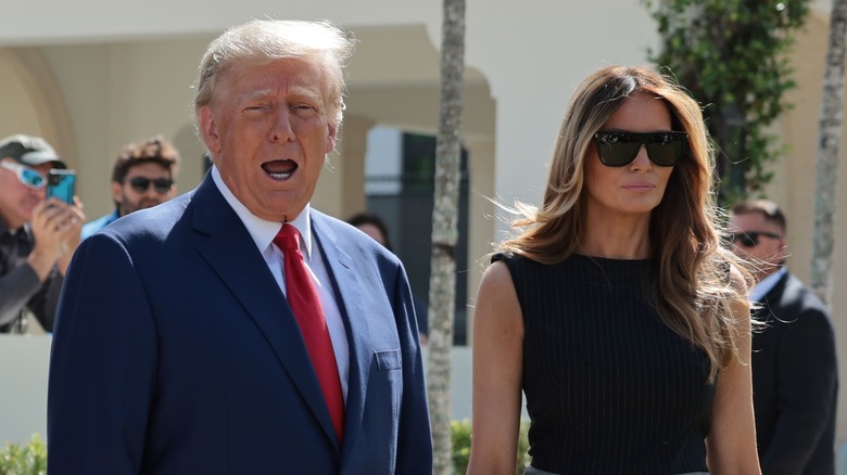 Donald Trump with open mouth beside Melania Trump