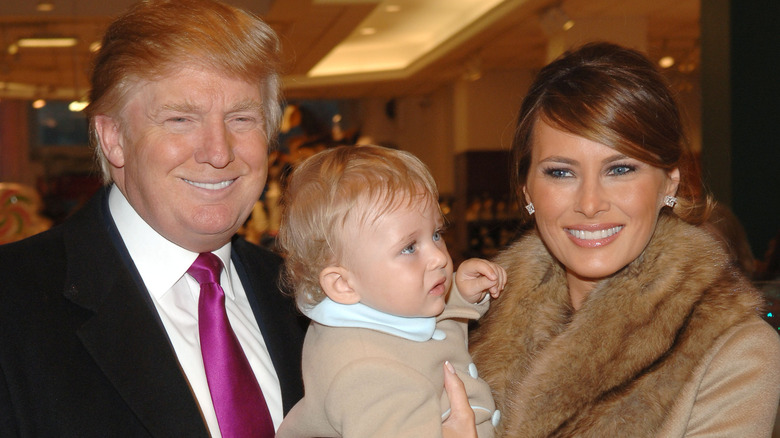 Donald Trump and Melania Trump holding baby Barron Trump